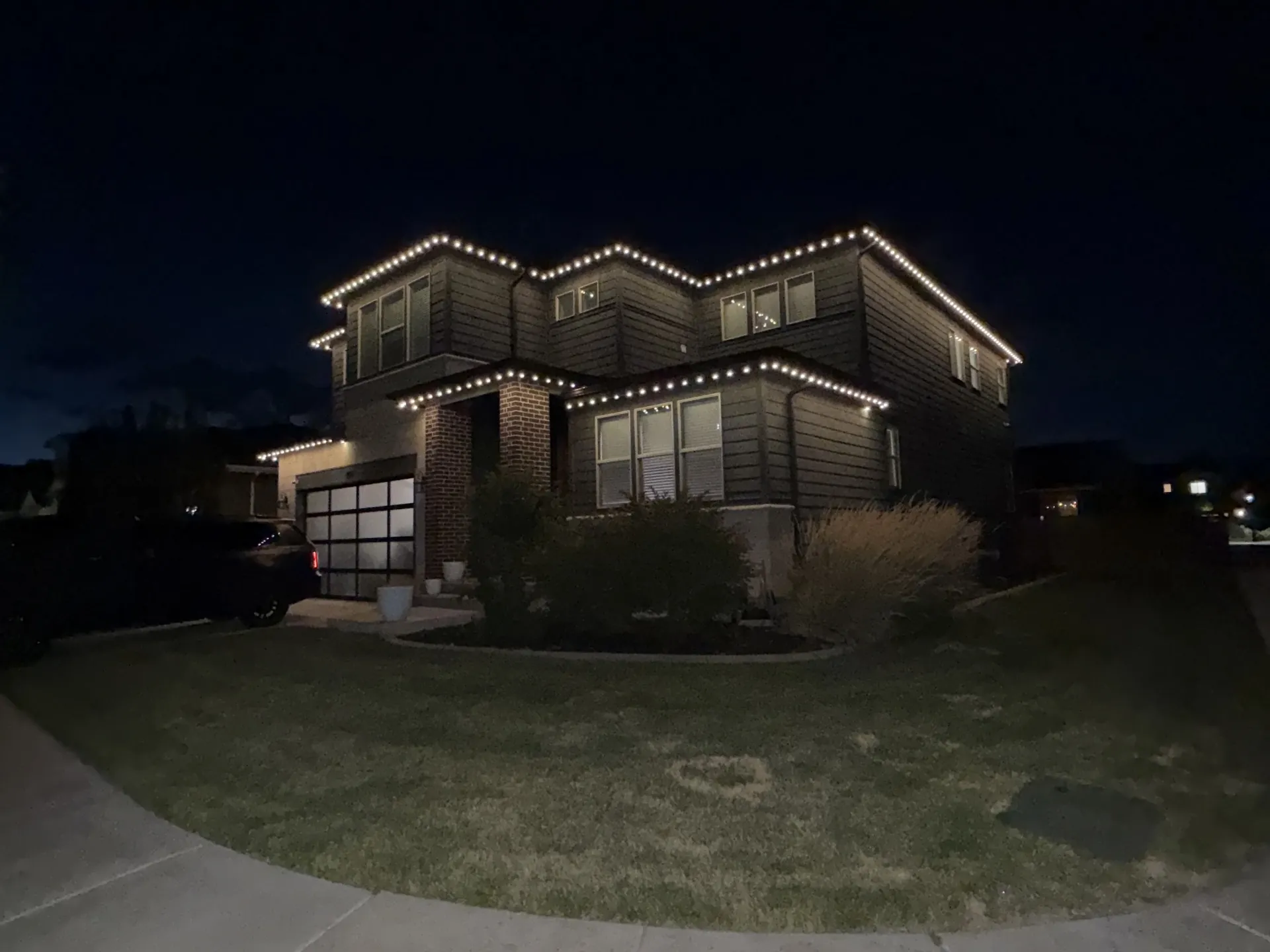 Home exterior with permanent LED lights showcasing evening curb appeal