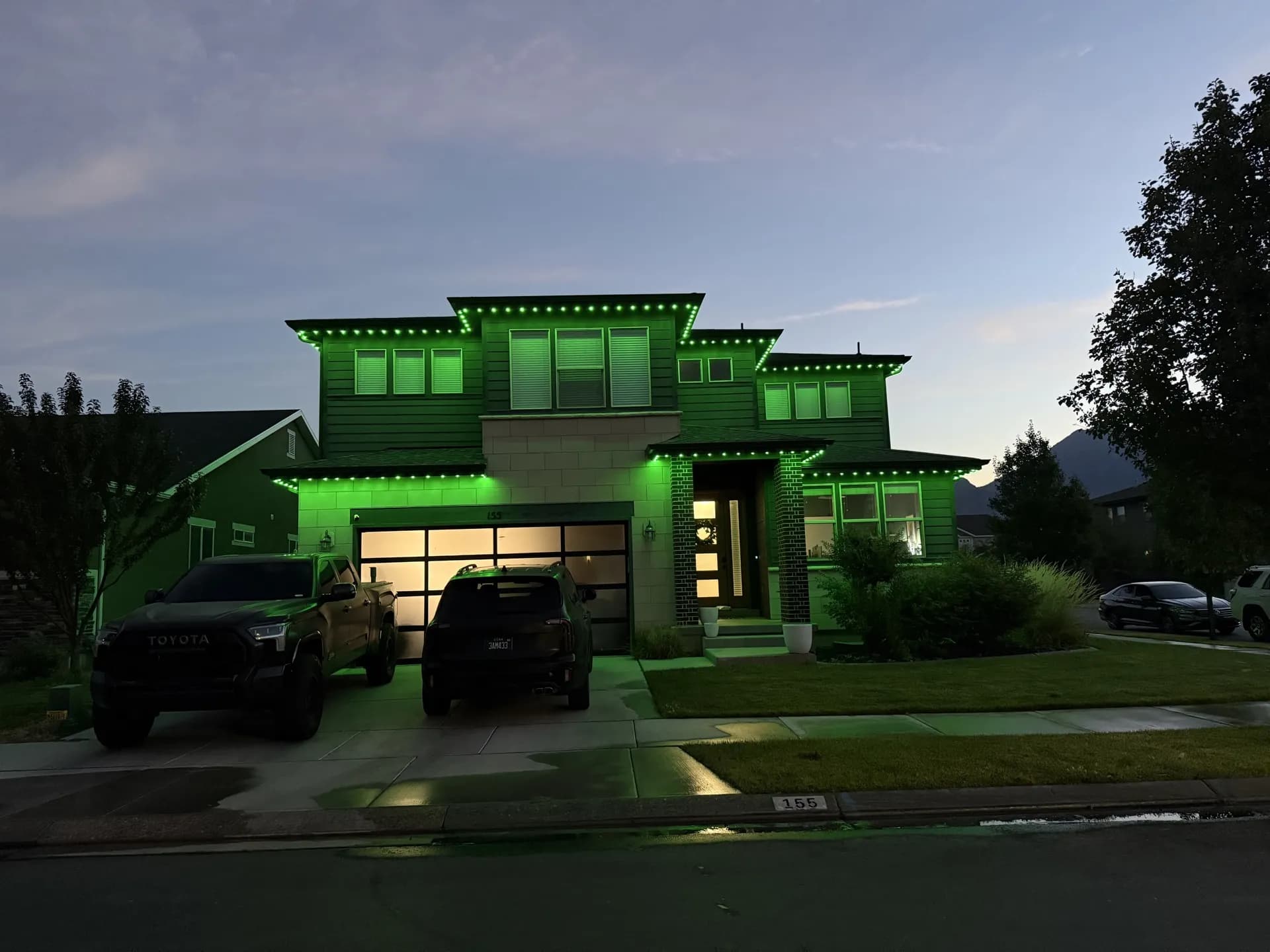 Suburban home with permanent LED accent lights at dusk