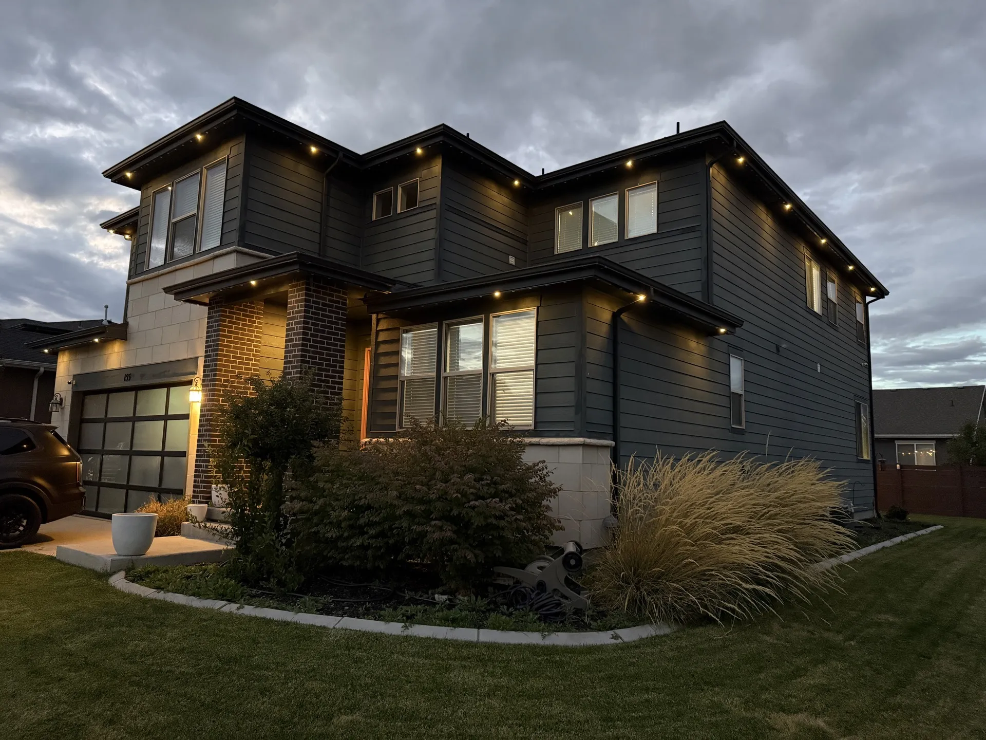 Home with permanent LED outdoor lighting along multiple rooflines