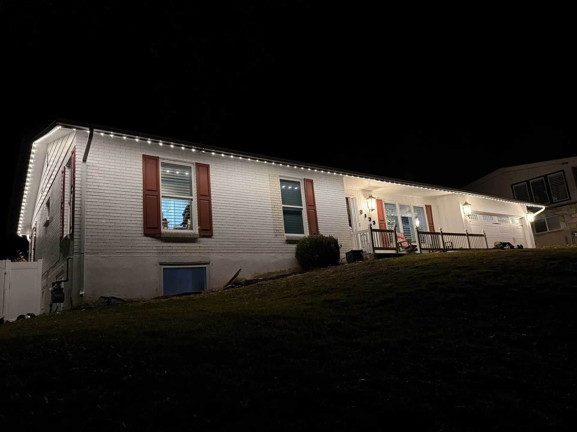 Large home with permanent outdoor LED lights along eaves